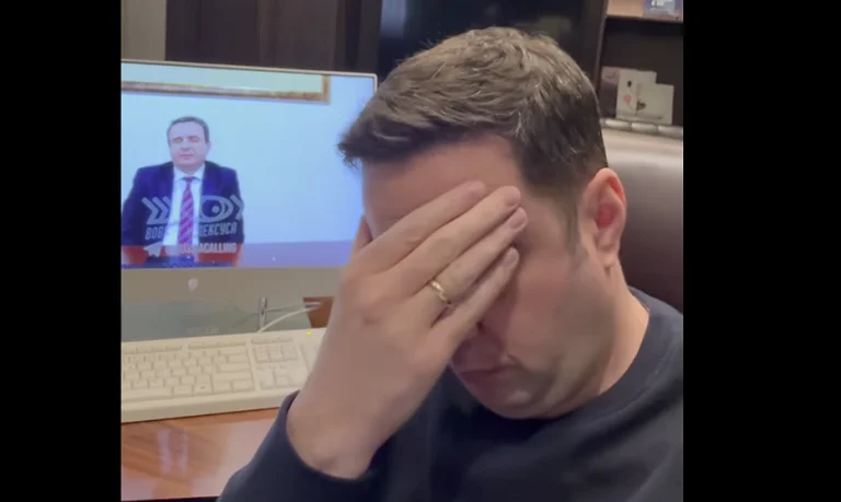 Obadiah grasps his head as he hears Kurt fall prey to Russian con men