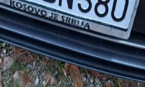 The three Montenegrins showing license plates “Kosovo is Serbia”