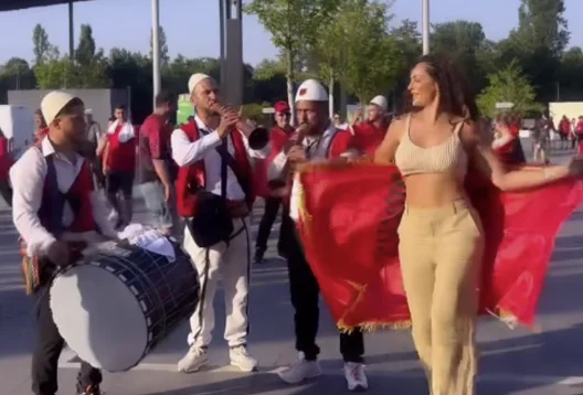 With a red and black flag, Julie dances in Dusseldorf, Germany
