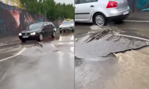Major rain clouds split the asphalt on B Street in Pristina