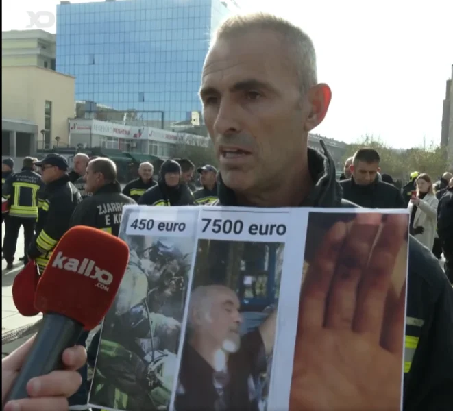 The protest fireman shows the burnt hand and pay he receives, compares them to the 7500th of Gani Jakup