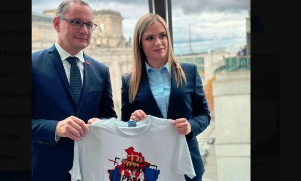 Heavy testing by Serbian MP, grants German MP his shirt where Kosovo map is covered with Serbian flag