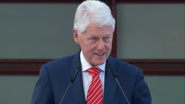 Clinton meets with the waiter who told him his family was alive because of him.