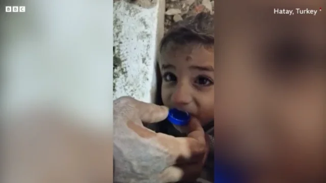 Trapped under ruins, the pups water him from the bottle cap