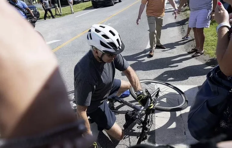 The unexpected happens to Biden, falling off his bike.
