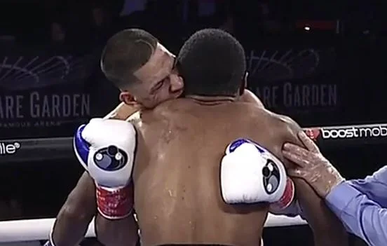 The young boxer like Mike Tyson bites his opponent's ear and wins the match