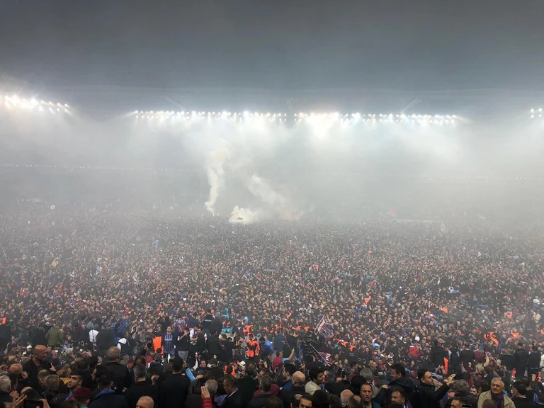 V It's not a protest. It's a Trabzonspor fan who has invaded the field to celebrate the title.
