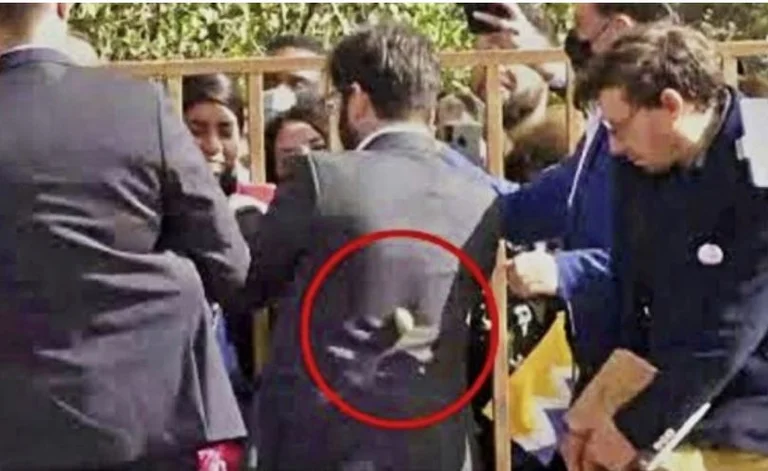 Nel momento in cui il presidente cileno esce dalla capitale, qualcuno gli lancia delle pietre.
