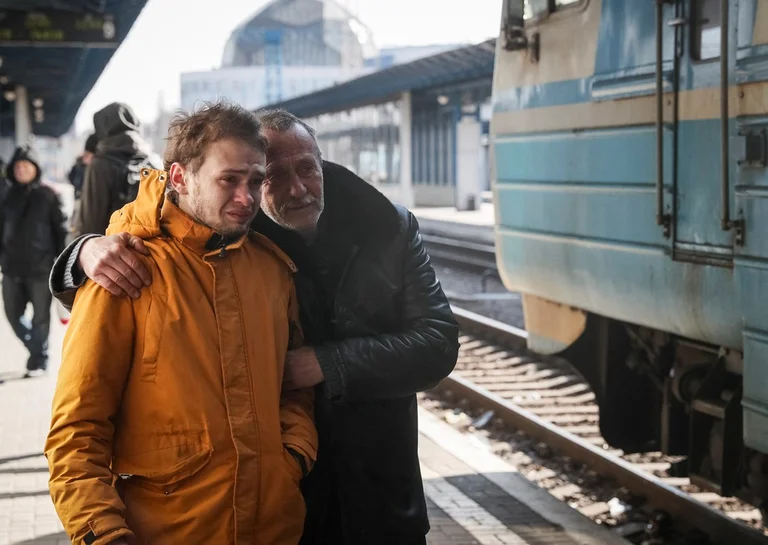 Touch: Father and son say goodbye to family who leave on an evacuation train