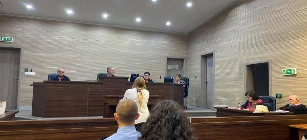 Left with eight orphaned children and two - week - olds, a wife seeks justice for her husband's murder