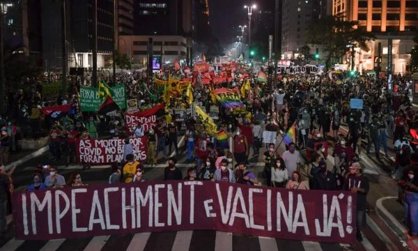Thousands of protesters in Brazil seek to blame president and better access to vaccines