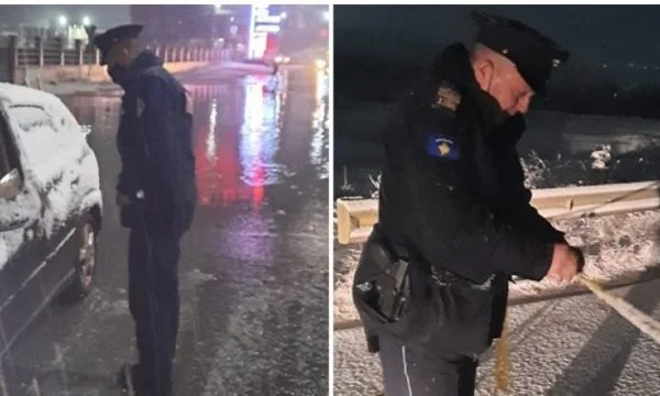 Police officials help citizens in Drenas after the floods