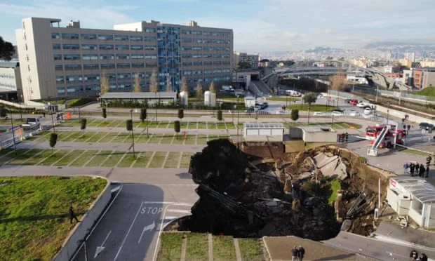 A giant pit dug in Naples, Italy, eats some cars