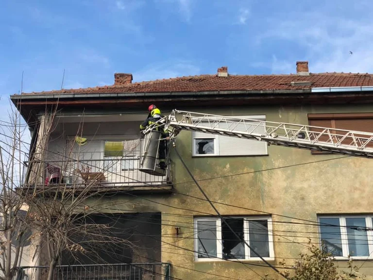 The moment the old woman is saved from fire in Vushtrri