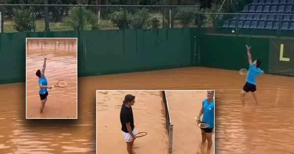The two tennis players don't stop anything, play in the flooded field