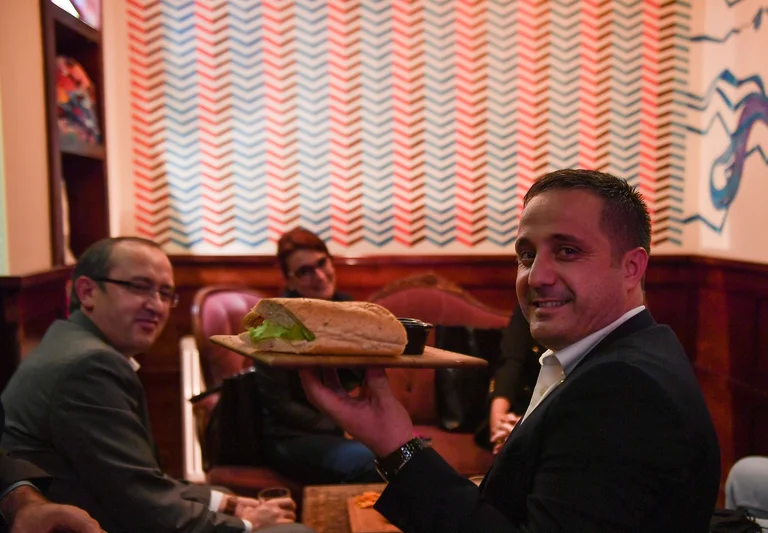 Hoti appears at one of the bars in Pristina, believed not to go with the sandwich from the house