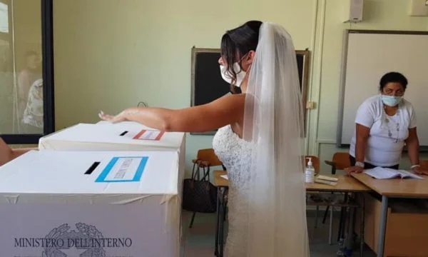 La novia va en vestido blanco para votar justo después del matrimonio