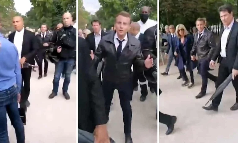 Yelekvertu Missbrauch Präsident Macron und seine Frau, als sie durch Paris gingen