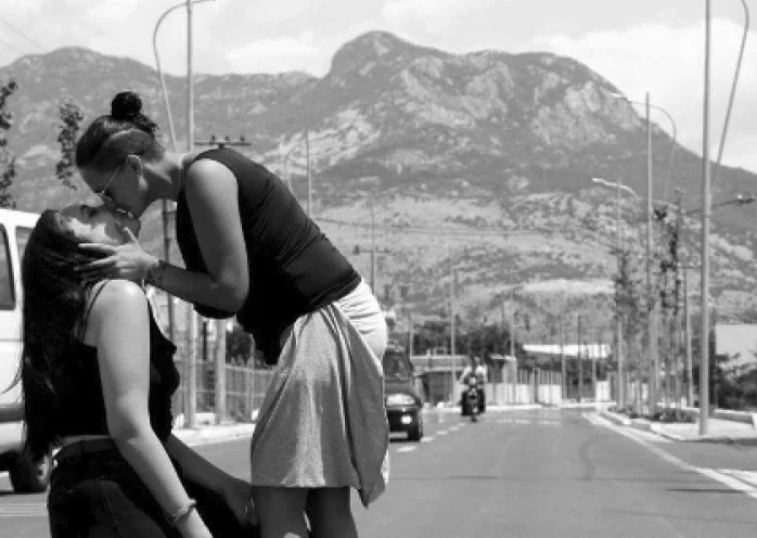 The photographer who developed the picture of two lesbians kissing at Shkodra gets the message that changes her day.