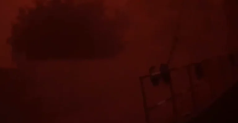 God's punishment: The sky turns black at daylight, red apocalypse clouds covering the city