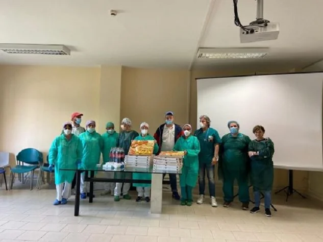 Italy: Two Albanian cooks set up elderly people's house table