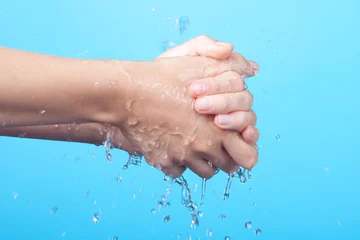 Why should hot water not be used while washing hands?