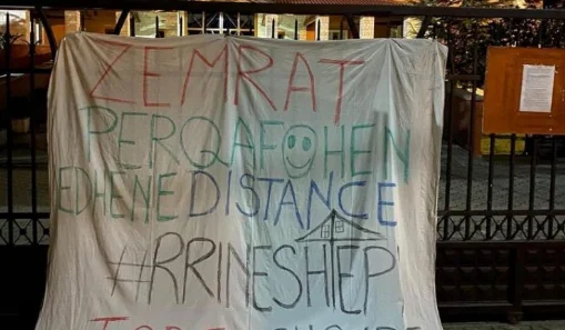 The cathedral in Albania places the banner where it says: Hearts are embraced and in distance
