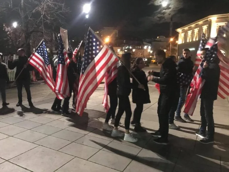 Students place US flags in front of government building