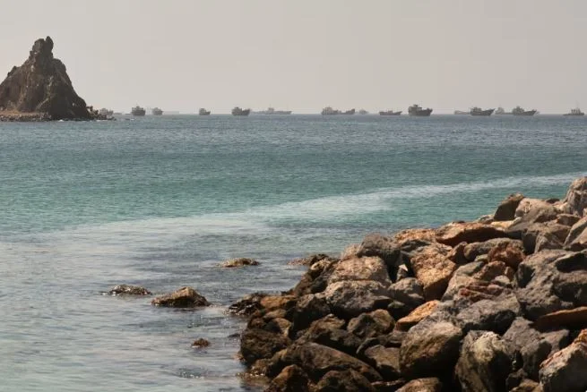 A shell strikes an oil tank near the Strait of Hormuz