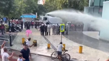 Tensions outside Albania's Parliament, police water protesters